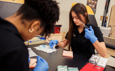 Image of student practicing healing a wound.