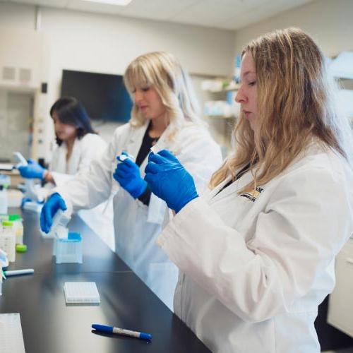 Opportunities in PGx - Image of students measuring ingredients.